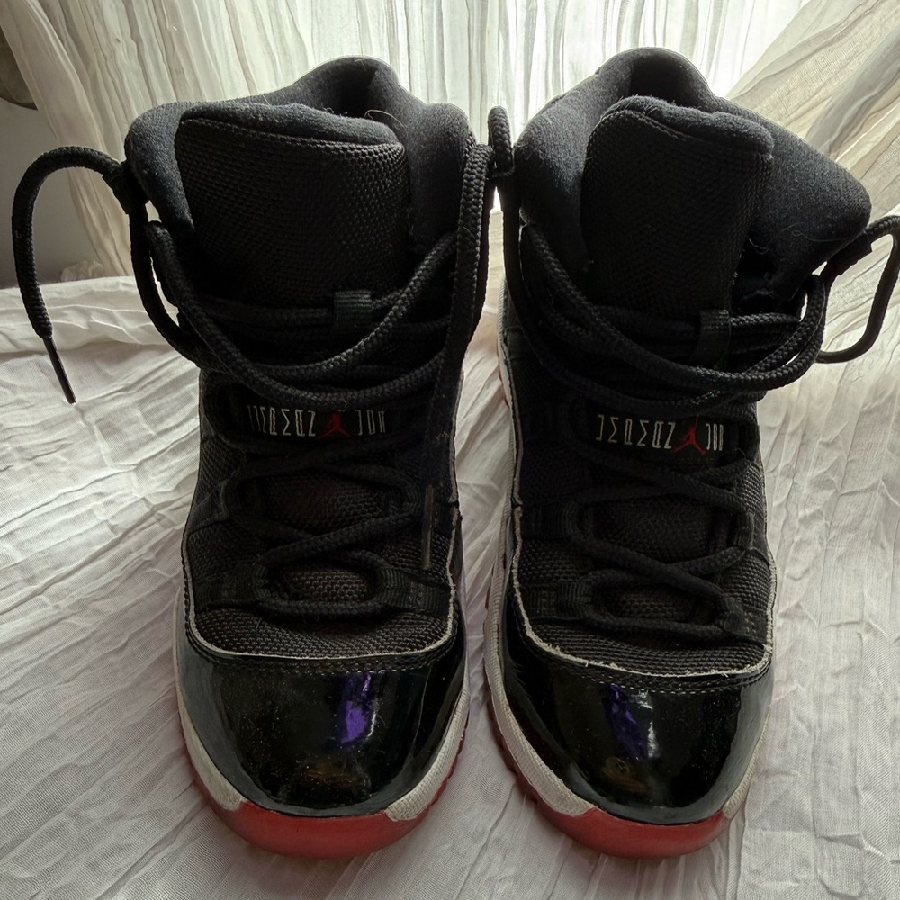 JORDAN 11 Black and Red High-Top Sneaker